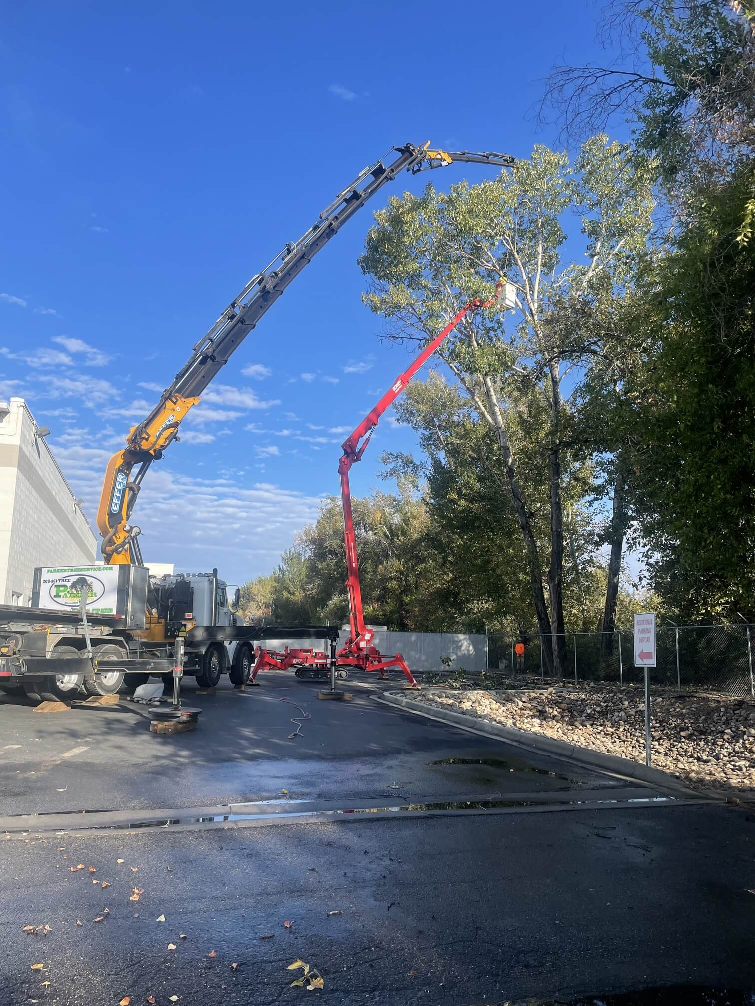 Parker Tree Service cranes and equipment at a commercial tree care job